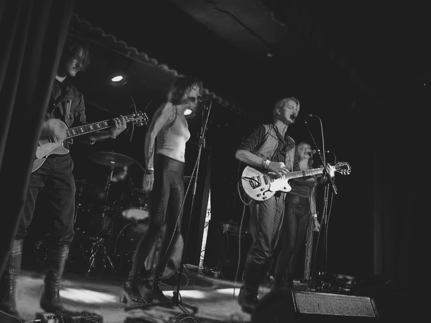 Thalo playing live under red stage lights